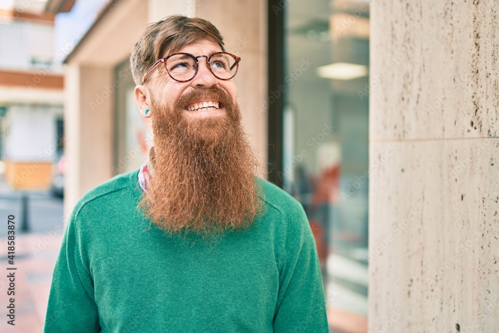 Young irish man with redhead beard smiling happy walking at the city. Young irish man with redhead beard smiling happy walking at the city.
