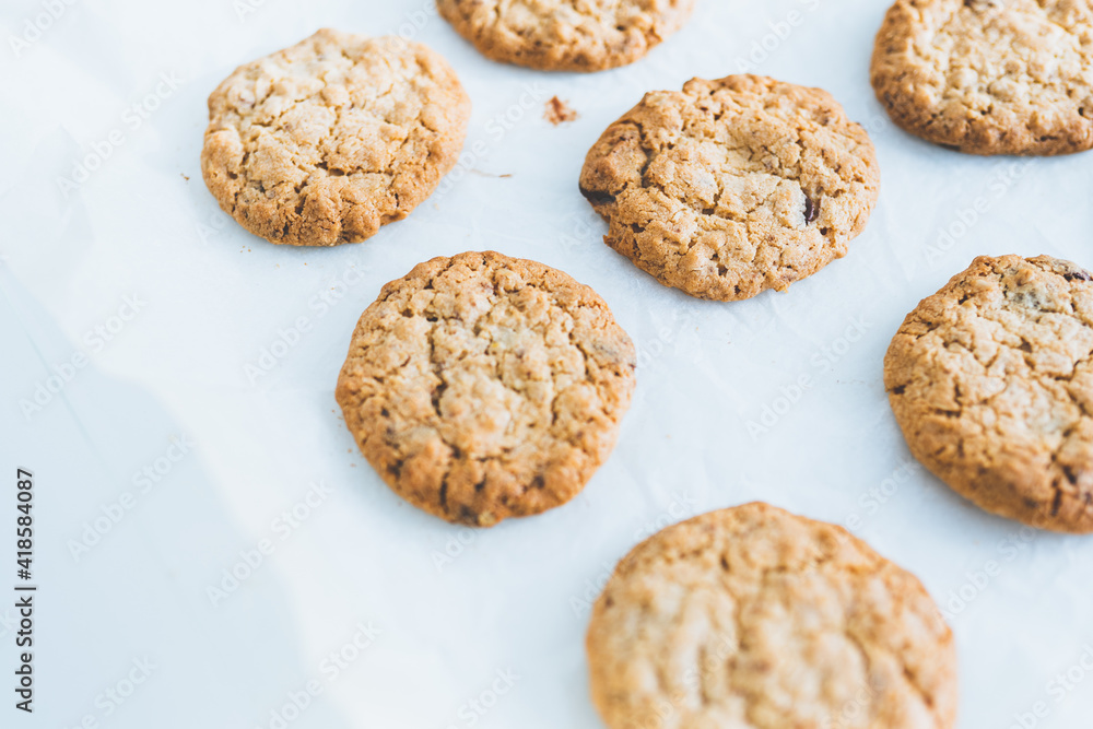 Oatmeal homemade cookies on white table. Space for text. Healhy desserts.