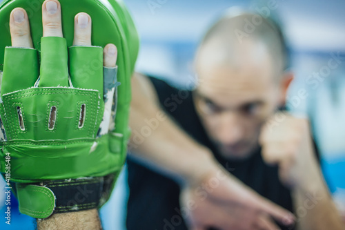 Elbow kick technique training with focus mitts. Elbow strike and punch photo