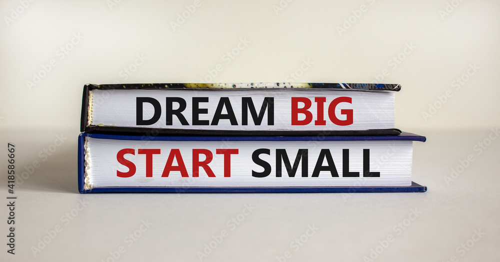 Dream big start small symbol. Concept words 'dream big start small' on books on a beautiful white background. Business, motivational and dream big start small concept.