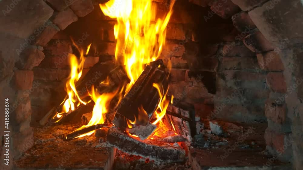 Video of wood burning fireplace. antique stone fireplace. Fire is burning in the fireplace. Hearth. Warmth and home comfort. Flames of a village house. Video of wood burning fireplace. antique stone fireplace. Fire is burning in the fireplace. Hearth. Warmth and home comfort. Flames of a village house.