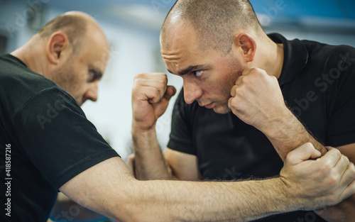 Sparring training and demonstration of street fight technique against attacker photo