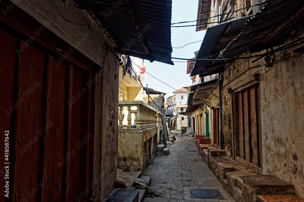 Stonetown (Tanzania, Zanzibar Archipelago). Streets and harbour in old Stone Town of Zanzibar City, historical colonial stony buildings, narrow streets with stores and shops