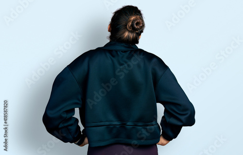 Young hispanic girl wearing sportswear standing backwards looking away with arms on body © Krakenimages.com