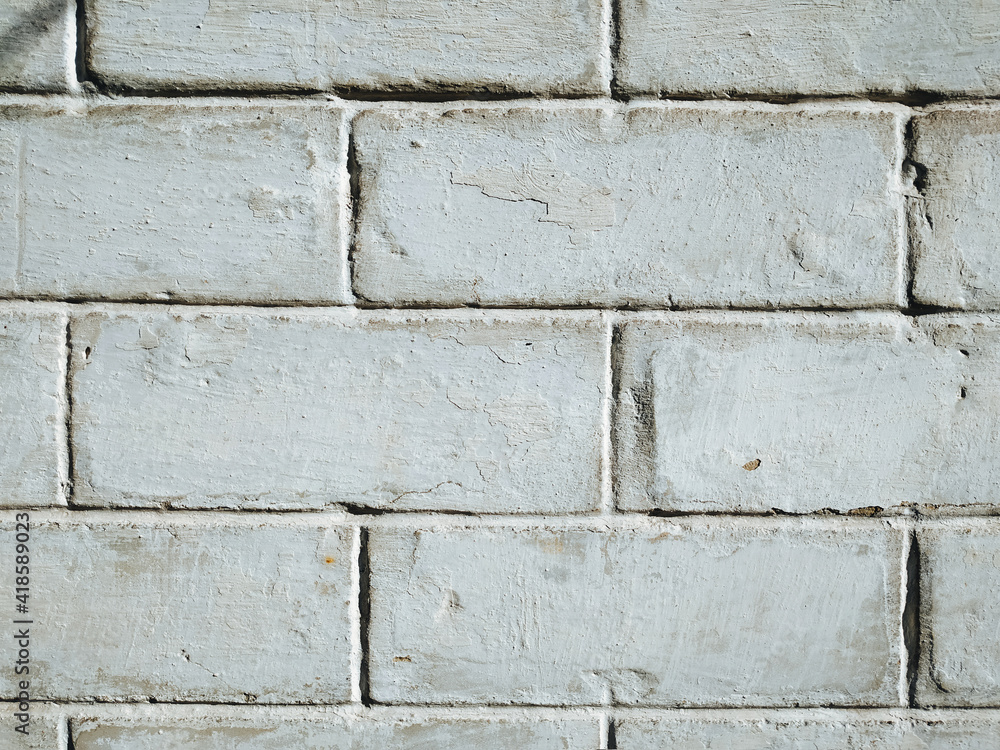 The texture of an old wall of white brick. Vintage, grunge background. The texture of an old wall of white brick. Vintage, grunge background.