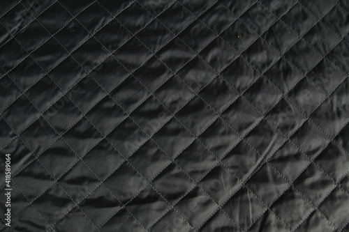 Factory quilted fabric in black. Abstract background