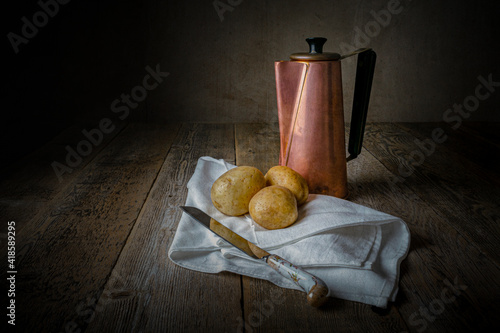 Copper jug and potatoes.