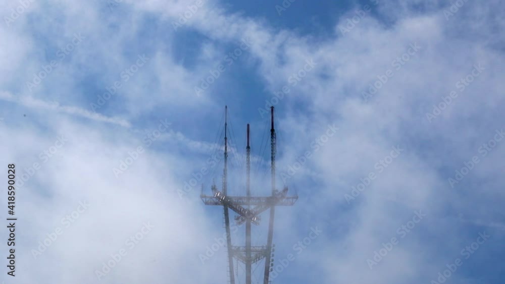 Slow motion shot of metallic towers against blue sky on sunny day - San Francisco, California Slow motion shot of metallic towers against blue sky on sunny day - San Francisco, California