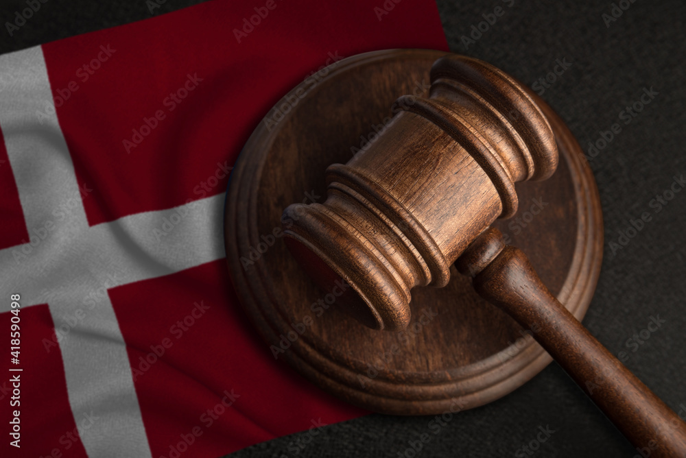 Judge gavel and flag of Denmark. Law and justice in Denmark. Violation of rights and freedoms