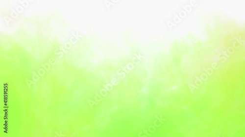 Yellow and green ink spreading in water on white. Abstract color background, liquid smoke, psychedelic and art concept.