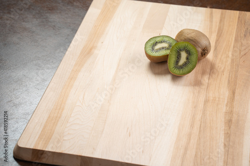 Kiwi fruit on wooden cutting board