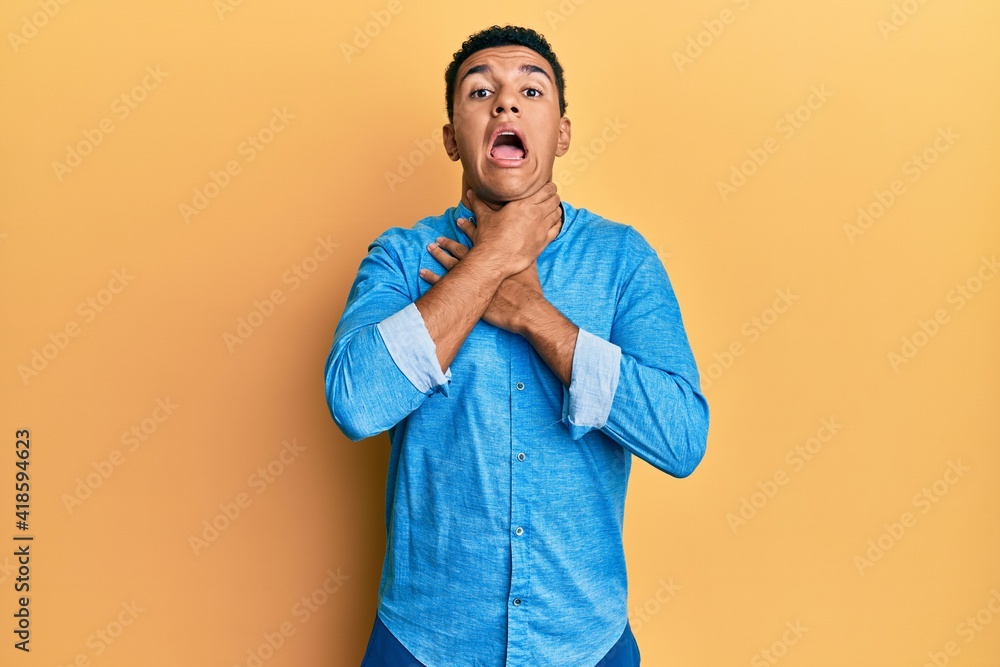 Young arab man wearing casual clothes shouting and suffocate because painful strangle. health problem. asphyxiate and suicide concept. Young arab man wearing casual clothes shouting and suffocate because painful strangle. health problem. asphyxiate and suicide concept.
