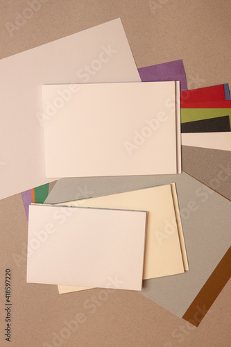 stack of books and sheets  on gray background 
