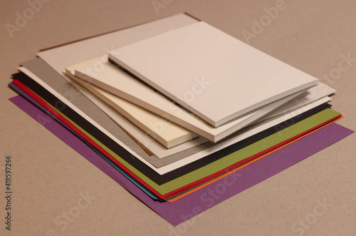 stack of books and sheets  on gray background 
