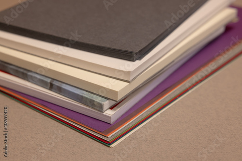 stack of books and sheets  on gray background 
