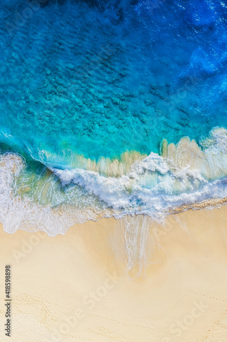 Travel and vacation image. Coast as a background from top view. Blue water background from air. Summer seascape from drone. Strong waves.