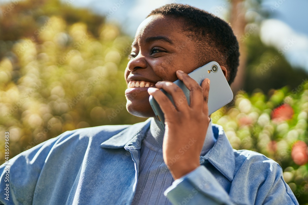 Young african american woman smiling happy talking on the smartphone at the city Young african american woman smiling happy talking on the smartphone at the city
