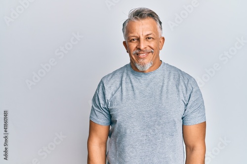 Middle age grey-haired man wearing casual clothes with a happy and cool smile on face. lucky person.