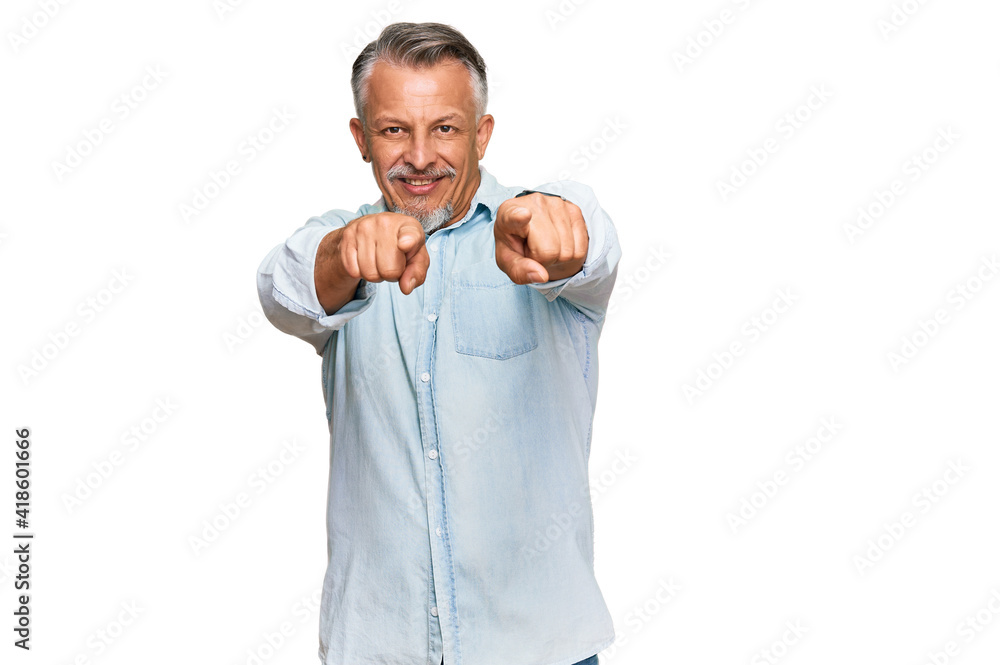 Fototapeta premium Middle age grey-haired man wearing casual clothes pointing to you and the camera with fingers, smiling positive and cheerful