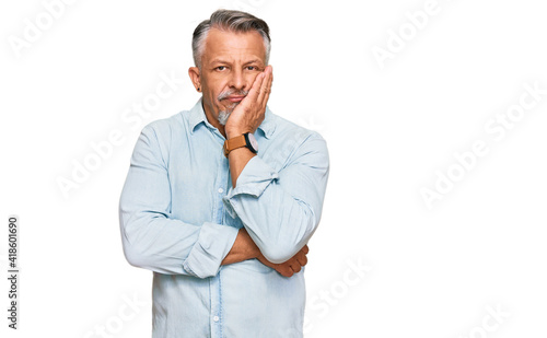 Middle age grey-haired man wearing casual clothes thinking looking tired and bored with depression problems with crossed arms. © Krakenimages.com