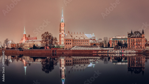 Cathedral of St. John the Baptist, Collegiate Church of the Holy Cross and Saint Bartholomew in Wroclaw on the Odra River, illuminated at night.