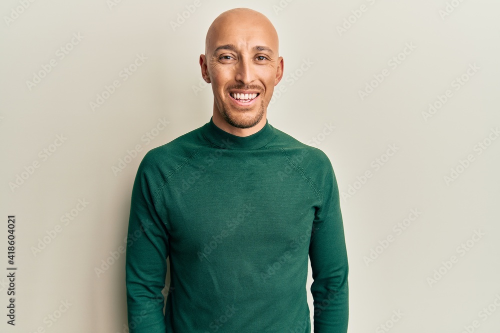 Bald man with beard wearing casual turtleneck sweater with a happy and cool smile on face. lucky person. Bald man with beard wearing casual turtleneck sweater with a happy and cool smile on face. lucky person.