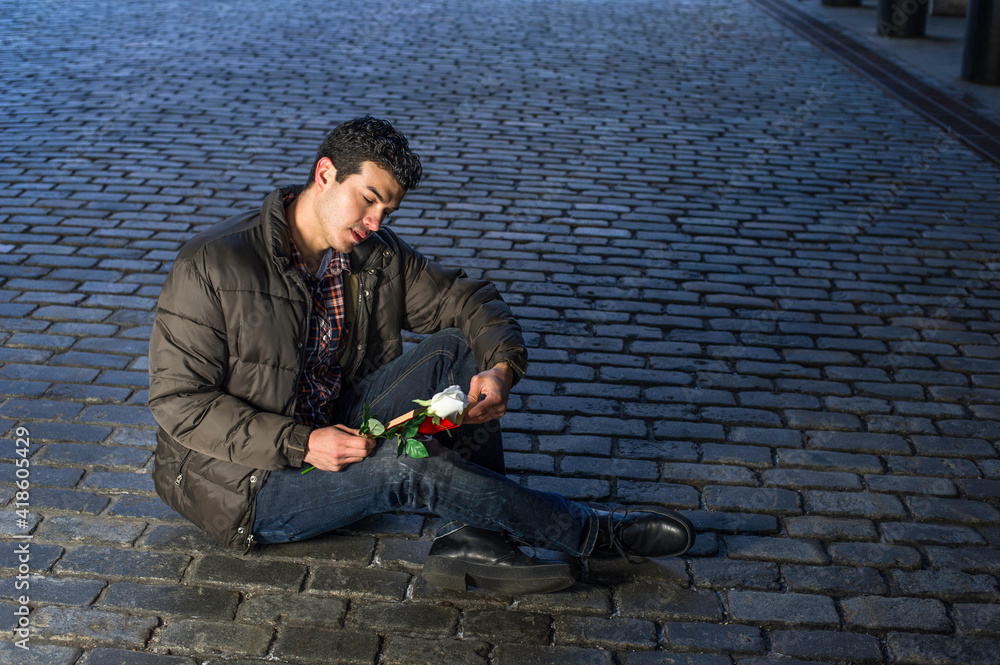 Young Man reading love story outside in New York City Young Man reading love story outside in New York City
