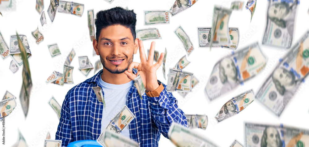 Obraz premium Handsome latin american young man holding vintage telephone doing ok sign with fingers, smiling friendly gesturing excellent symbol