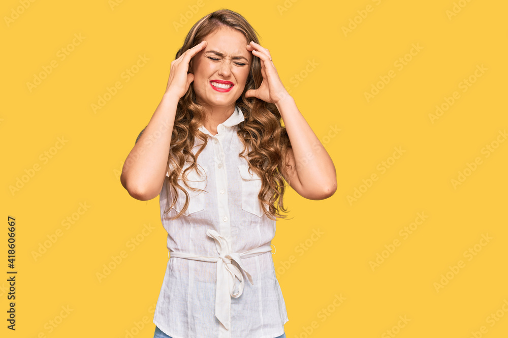 Young blonde girl wearing casual clothes with hand on head for pain in head because stress. suffering migraine. Young blonde girl wearing casual clothes with hand on head for pain in head because stress. suffering migraine.