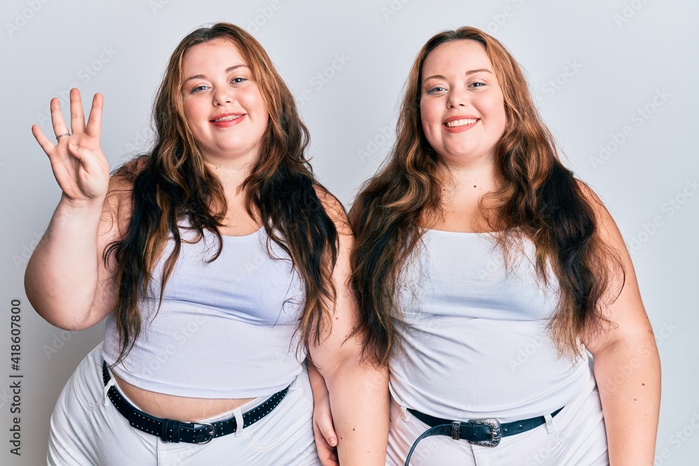 Plus size caucasian sisters woman wearing casual white clothes showing and pointing up with fingers number four while smiling confident and happy. Plus size caucasian sisters woman wearing casual white clothes showing and pointing up with fingers number four while smiling confident and happy.