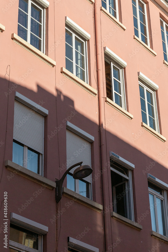 facade of a building in neutral pink colours in Lyon