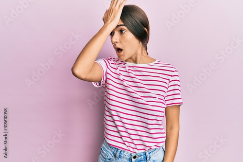Young hispanic woman wearing casual clothes surprised with hand on head for mistake, remember error. forgot, bad memory concept.