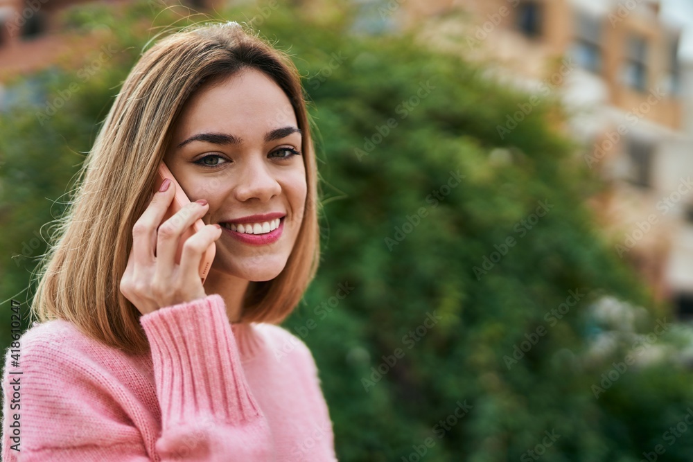 Young caucasian girl smiling happy talking on the smartphone at the city. Young caucasian girl smiling happy talking on the smartphone at the city.