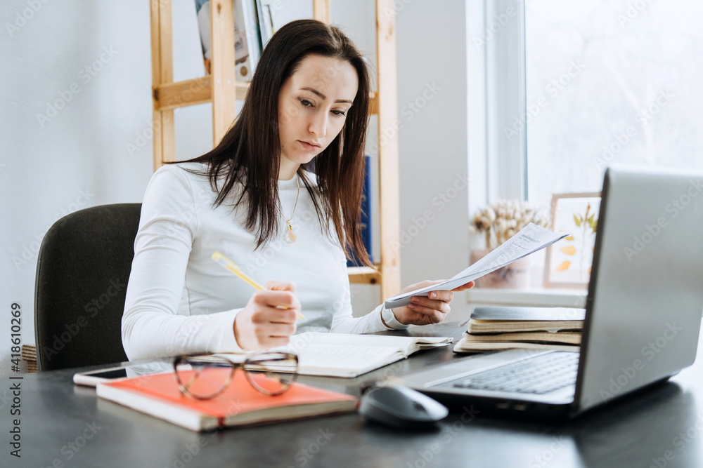 Small business, Self-employment, micro-entrepreneurs, accountant, ownership concept. Young businesswoman working with laptop and document from office at home Small business, Self-employment, micro-entrepreneurs, accountant, ownership concept. Young businesswoman working with laptop and document from office at home