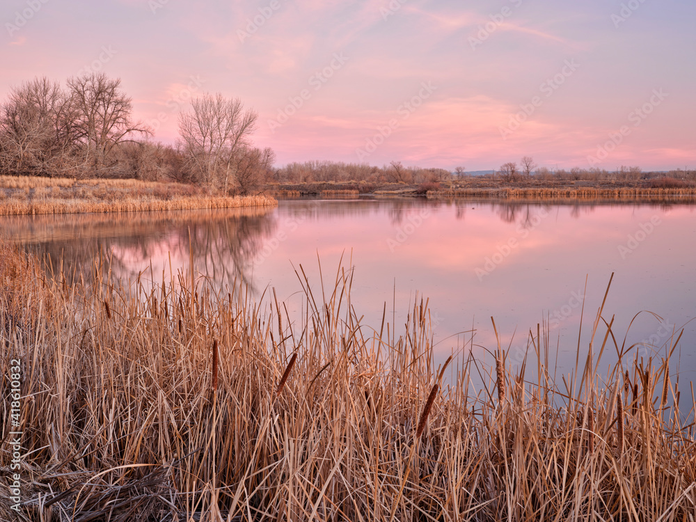 early spring dawn over a calm lake in one of natural areas along the Poudre River in Fort Collins, Colorado early spring dawn over a calm lake in one of natural areas along the Poudre River in Fort Collins, Colorado