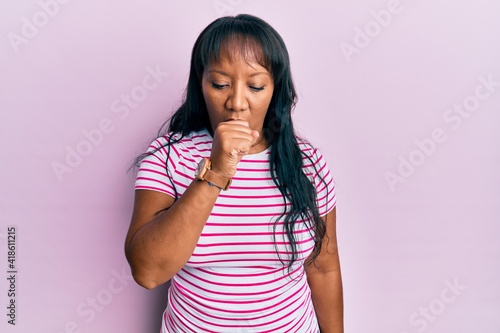 Middle age african american woman wearing casual clothes feeling unwell and coughing as symptom for cold or bronchitis. health care concept.