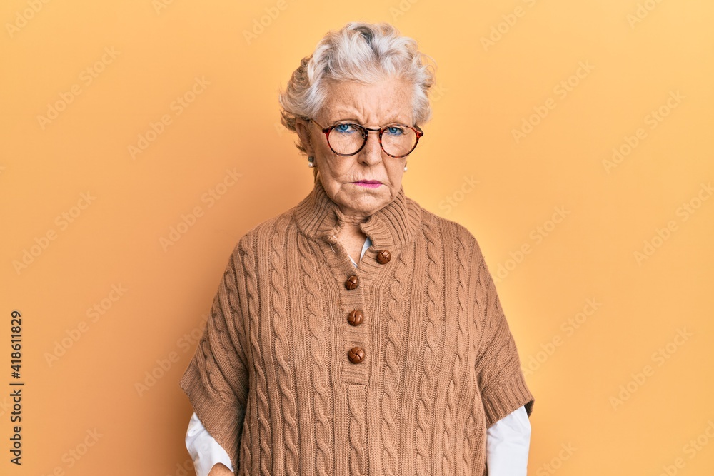 Senior grey-haired woman wearing casual clothes and glasses skeptic and nervous, frowning upset because of problem. negative person. Senior grey-haired woman wearing casual clothes and glasses skeptic and nervous, frowning upset because of problem. negative person.