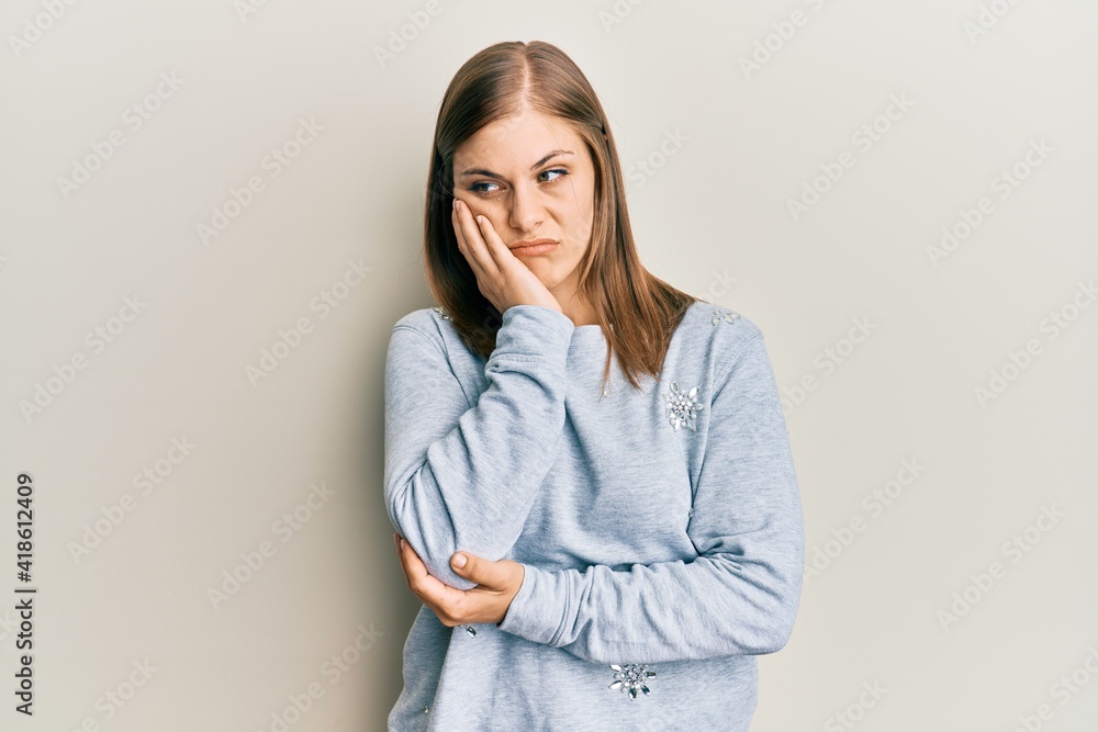 Beautiful caucasian woman wearing casual clothes thinking looking tired and bored with depression problems with crossed arms. Beautiful caucasian woman wearing casual clothes thinking looking tired and bored with depression problems with crossed arms.