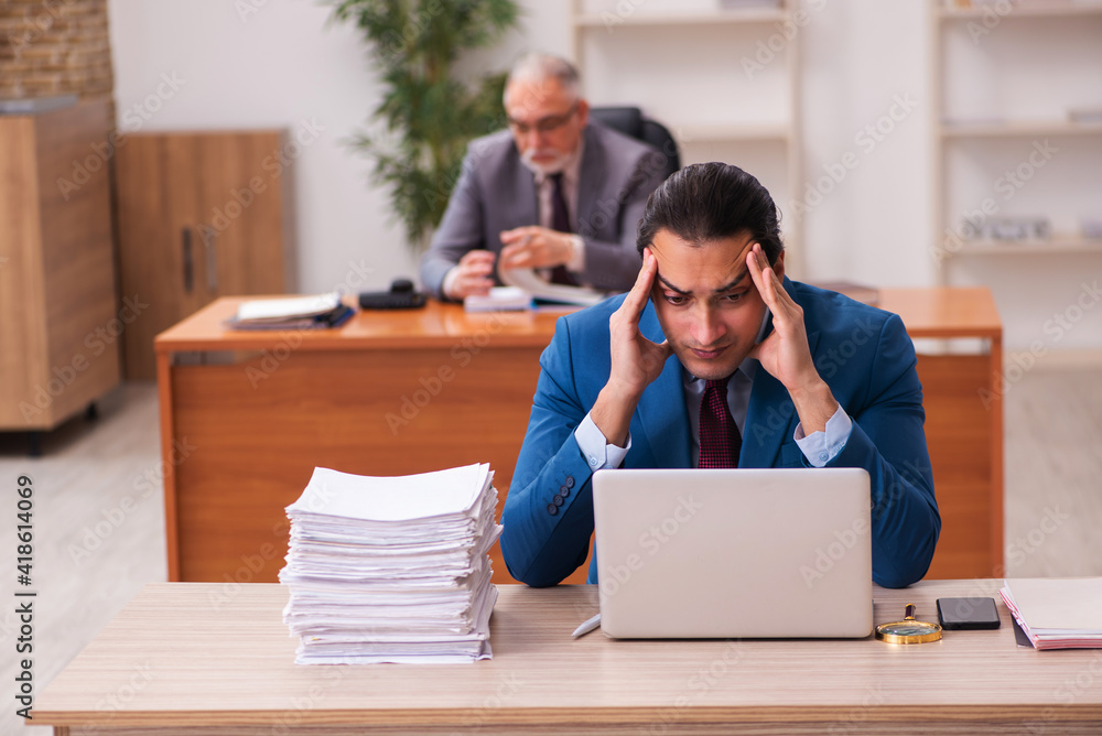 Two employees working in the office Two employees working in the office
