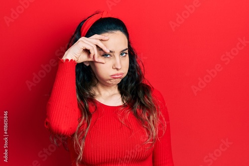 Young hispanic woman wearing casual clothes worried and stressed about a problem with hand on forehead, nervous and anxious for crisis
