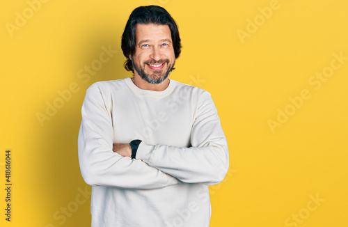 Middle age caucasian man wearing casual clothes happy face smiling with crossed arms looking at the camera. positive person.