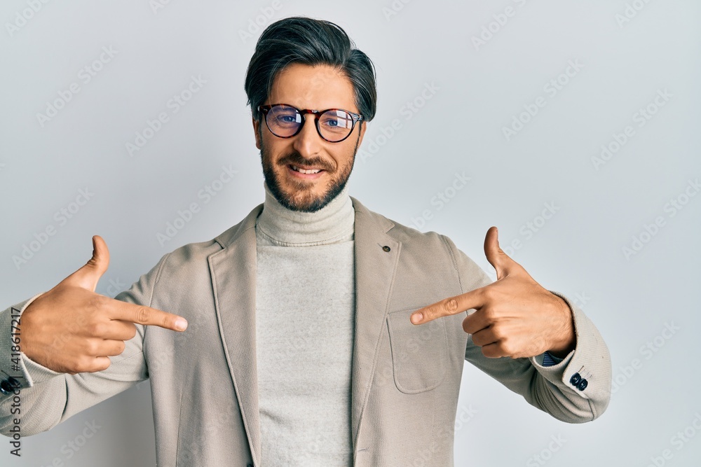 Young hispanic man wearing business jacket and glasses looking confident with smile on face, pointing oneself with fingers proud and happy. Young hispanic man wearing business jacket and glasses looking confident with smile on face, pointing oneself with fingers proud and happy.