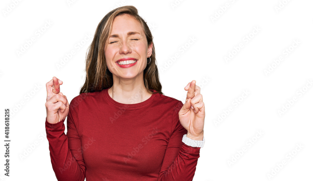 Young blonde woman wearing casual clothes gesturing finger crossed smiling with hope and eyes closed. luck and superstitious concept. Young blonde woman wearing casual clothes gesturing finger crossed smiling with hope and eyes closed. luck and superstitious concept.