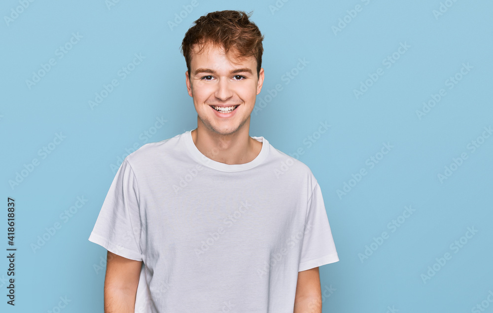 Young caucasian man wearing casual white t shirt with a happy and cool smile on face. lucky person. Young caucasian man wearing casual white t shirt with a happy and cool smile on face. lucky person.