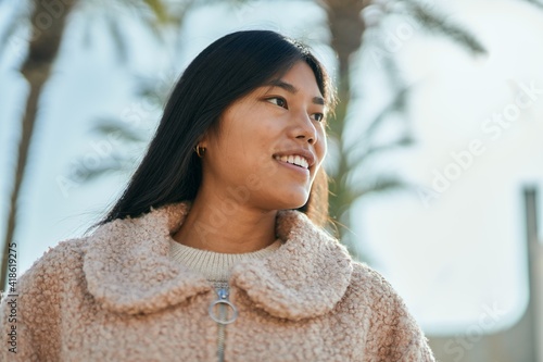Young asian woman smiling happy standing at the city.
