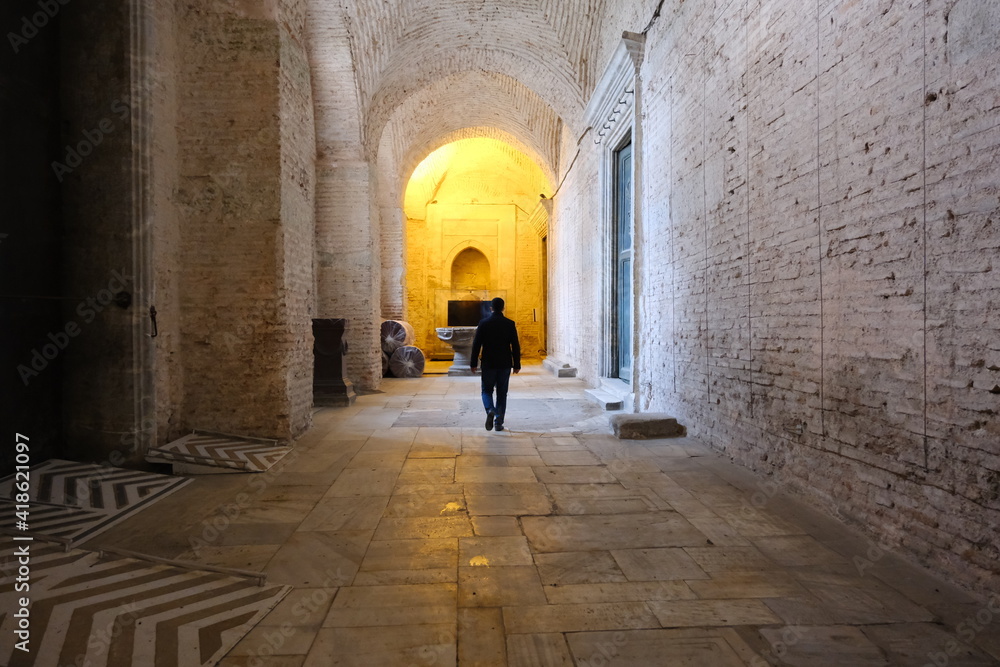 Turkey istanbul 03.03.2021. A man inside the hagia sophia mosque walking to yellow light