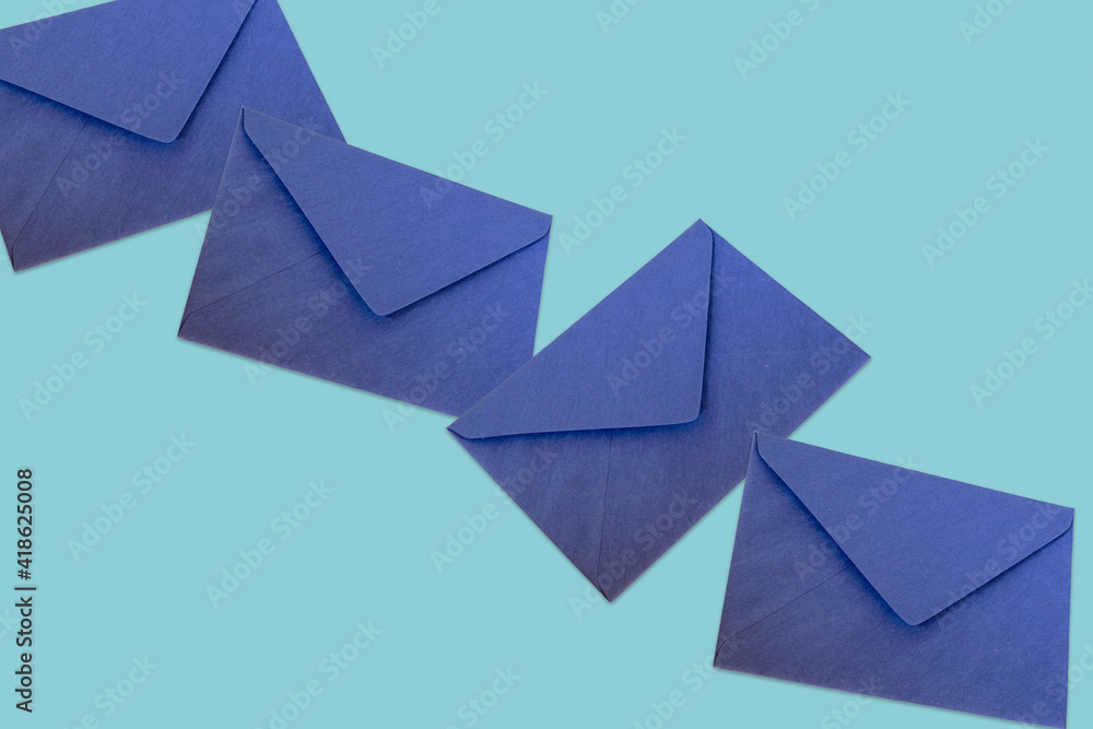 row of blue envelopes on the glass table row of blue envelopes on the glass table