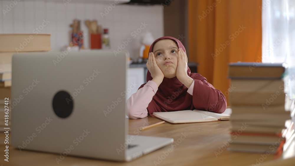 Little girl in a turban tired of being at home and learning from ...