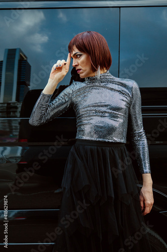 Transgender woman, posing, looking away, with a van background. Lgtb, transgender, gay pride and underground fashion concept. photo