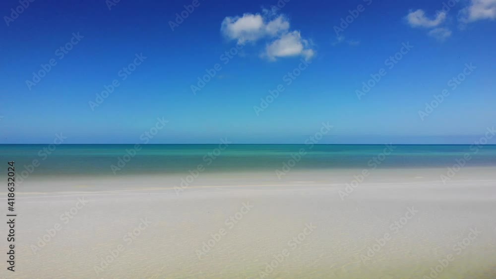 Beautiful top view of a paradise white sand beach. Calm water Beautiful top view of a paradise white sand beach. Calm water